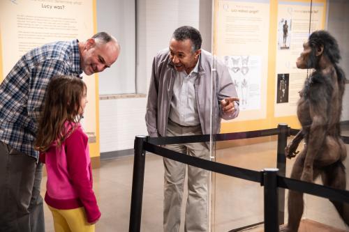 Visitors look at a 3D model of Lucy